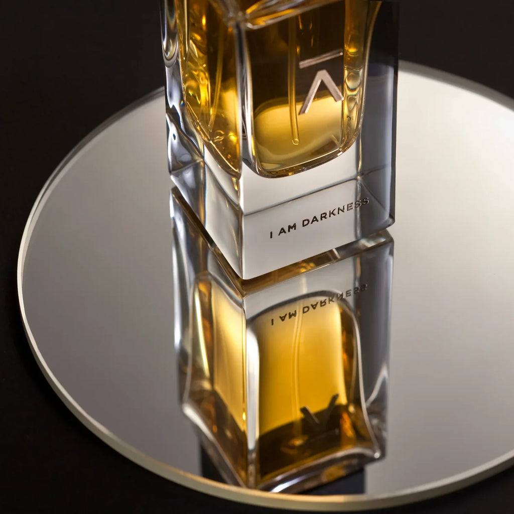 Azman I Am Darkness eau de parfum bottle reflected on a round mirror