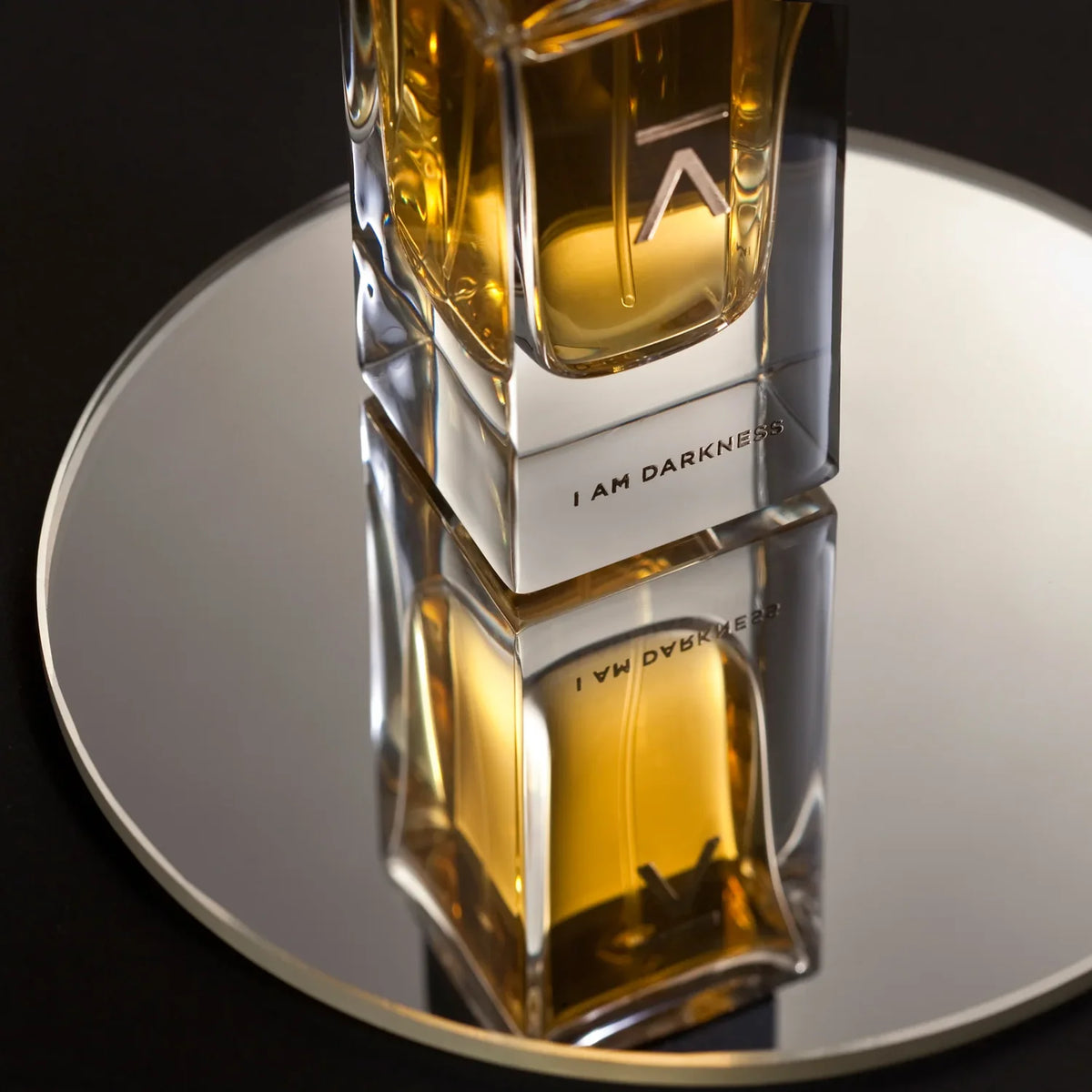 Azman I Am Darkness eau de parfum bottle reflected on a round mirror