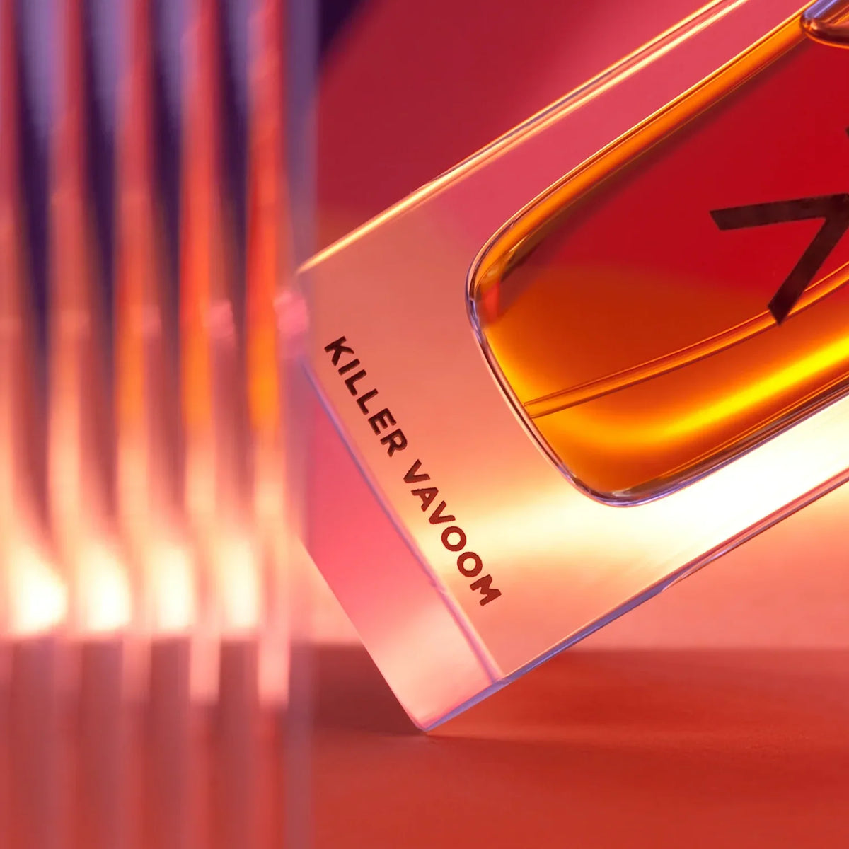 Azman Killer Vavoom parfum bottle tilted in red and amber light