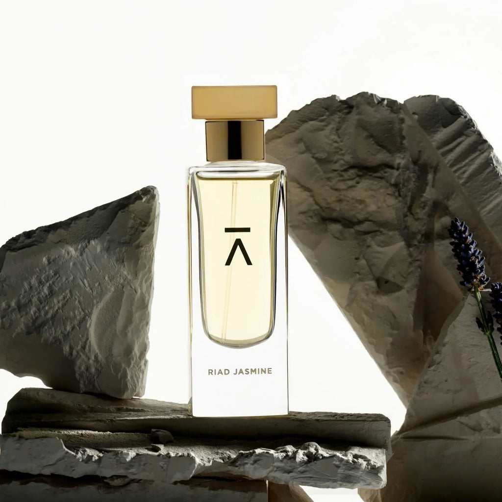 Azman Riad Jasmine eau de parfum bottle on pale stone with lavender