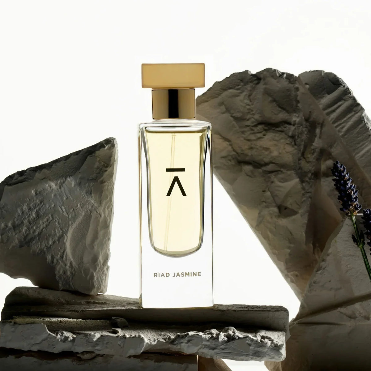 Azman Riad Jasmine eau de parfum bottle on pale stone with lavender