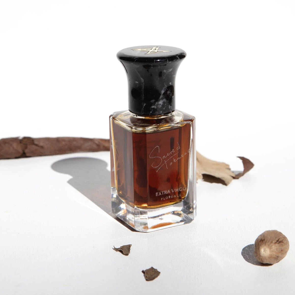 Extra Virgo Sacred Tobacco extrait de parfum bottle with tobacco leaves