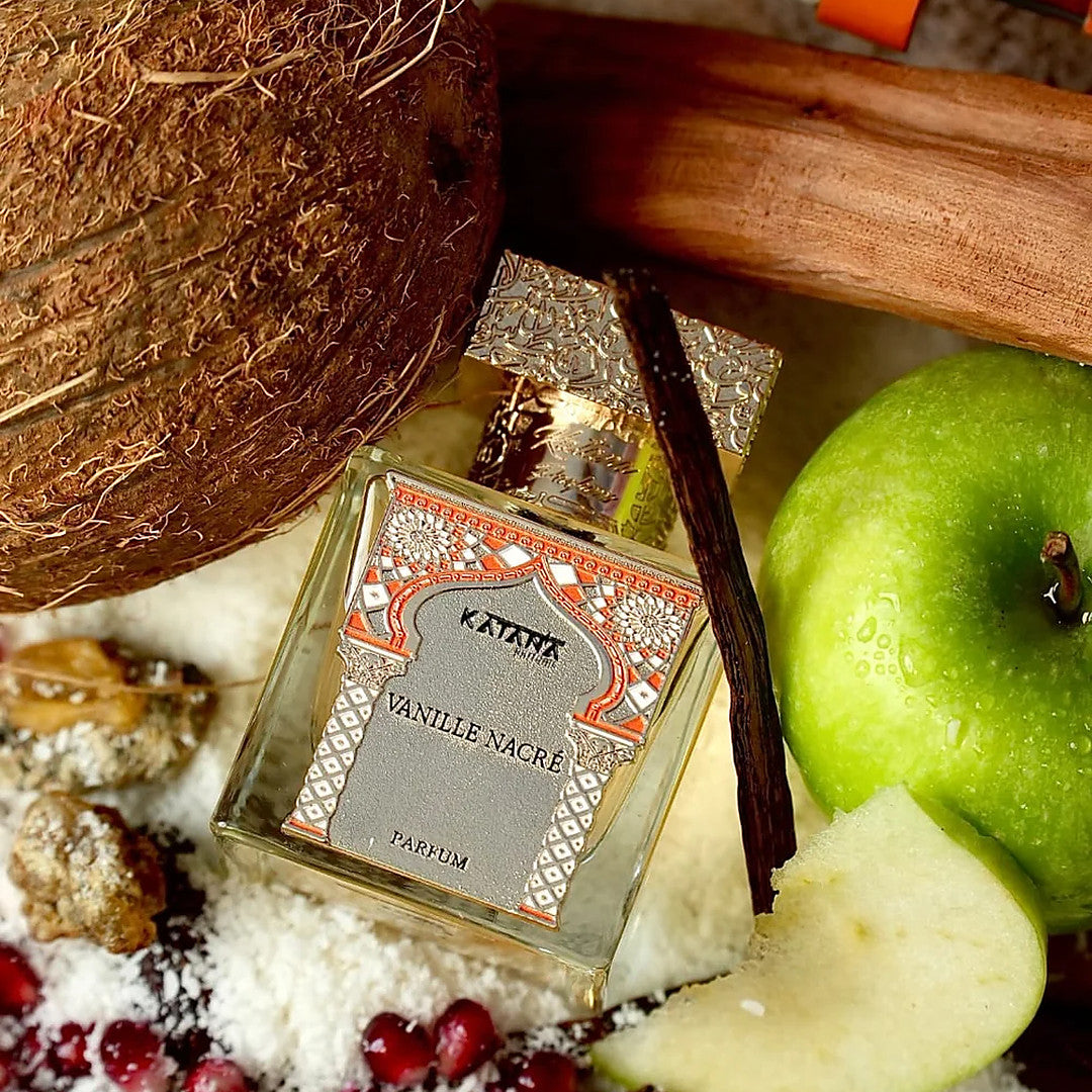 Katana Parfums Vanille Nacre parfum bottle resting among vanilla pods and coconut