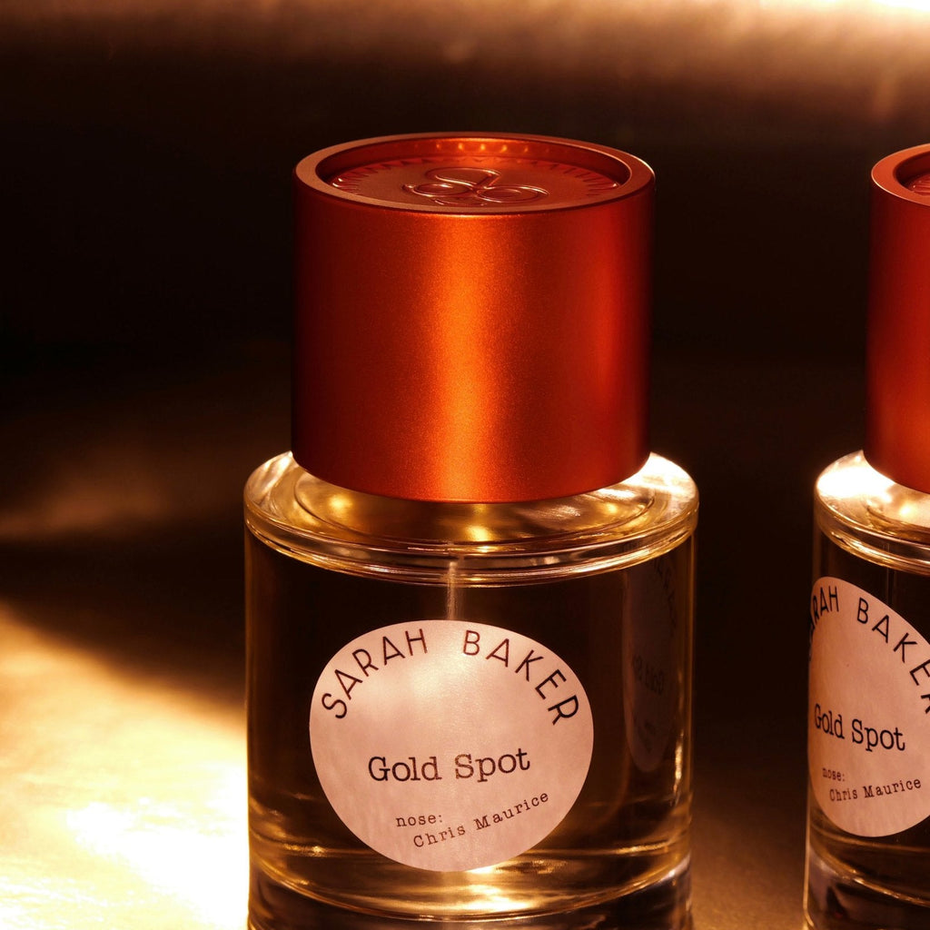 Sarah Baker Gold Spot bottles in warm golden light