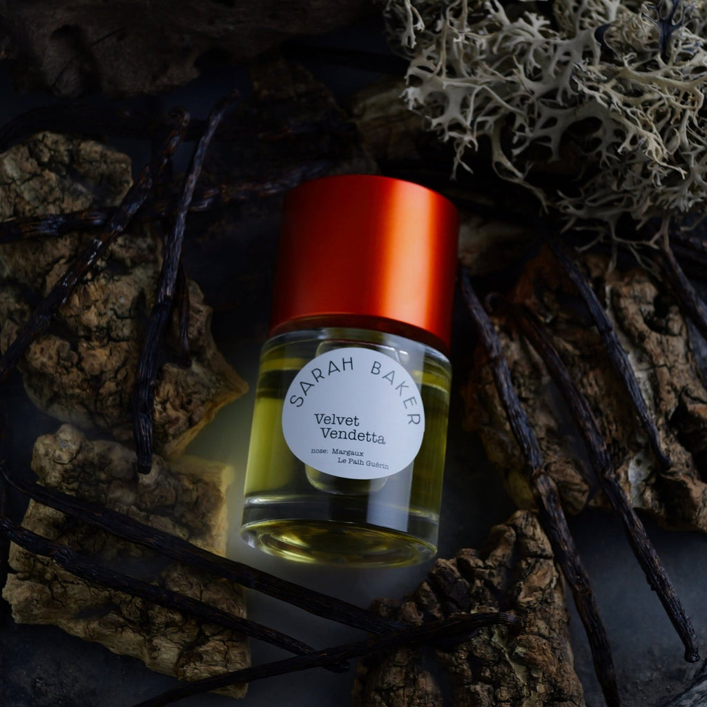Sarah Baker Velvet Vendetta among bark, lichen and vanilla pods