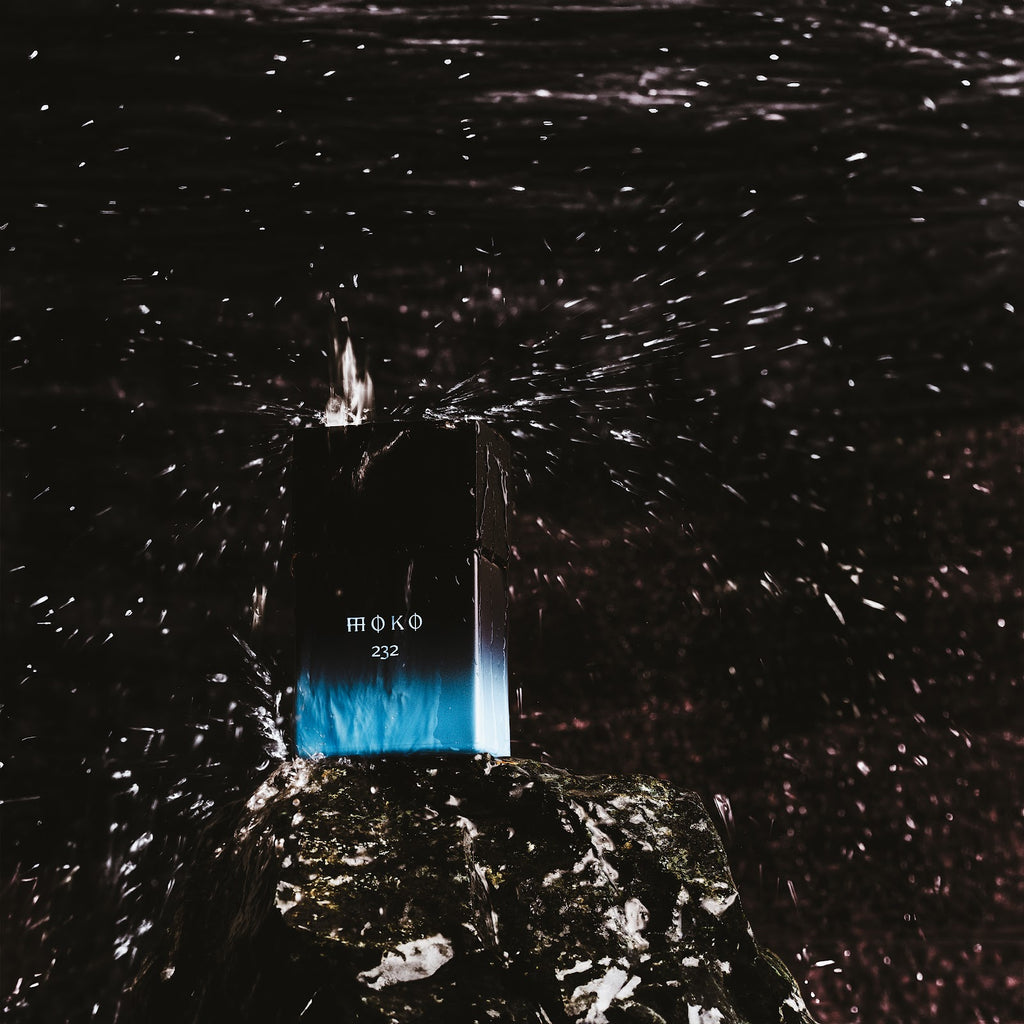 Wolf Brothers Moko eau de parfum bottle on wet dark ground