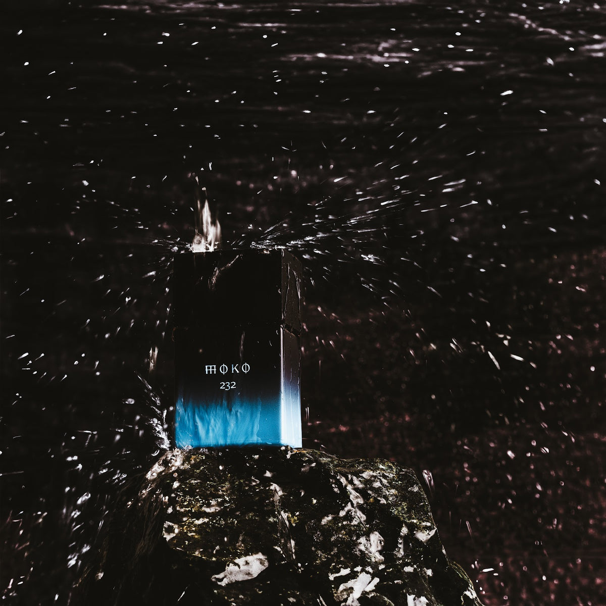 Wolf Brothers Moko eau de parfum bottle on wet dark ground
